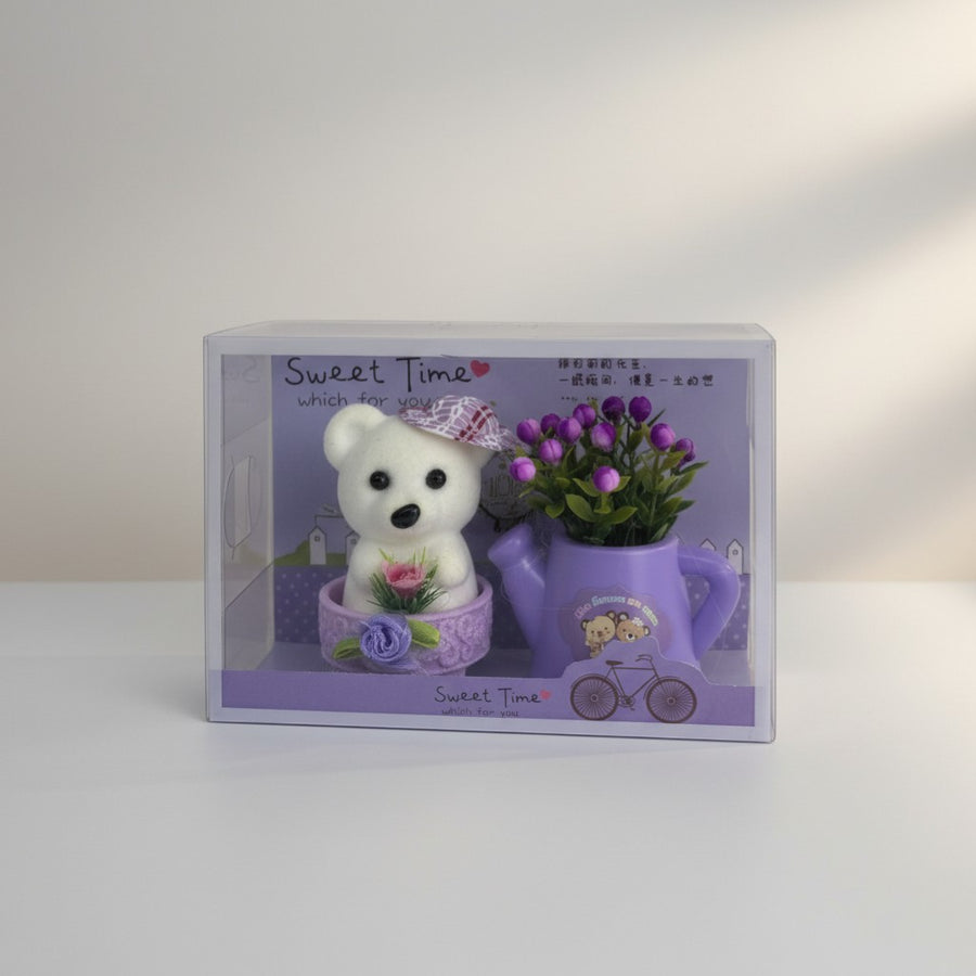 eRamis white teddy bear with purple hat and pink rose, in a purple pot with purple flowers.
