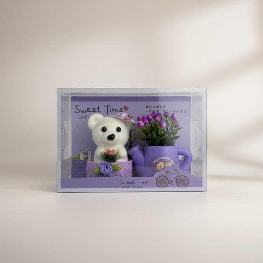 eRamis cute white teddy bear with purple hat and flowers, in a decorative watering can.