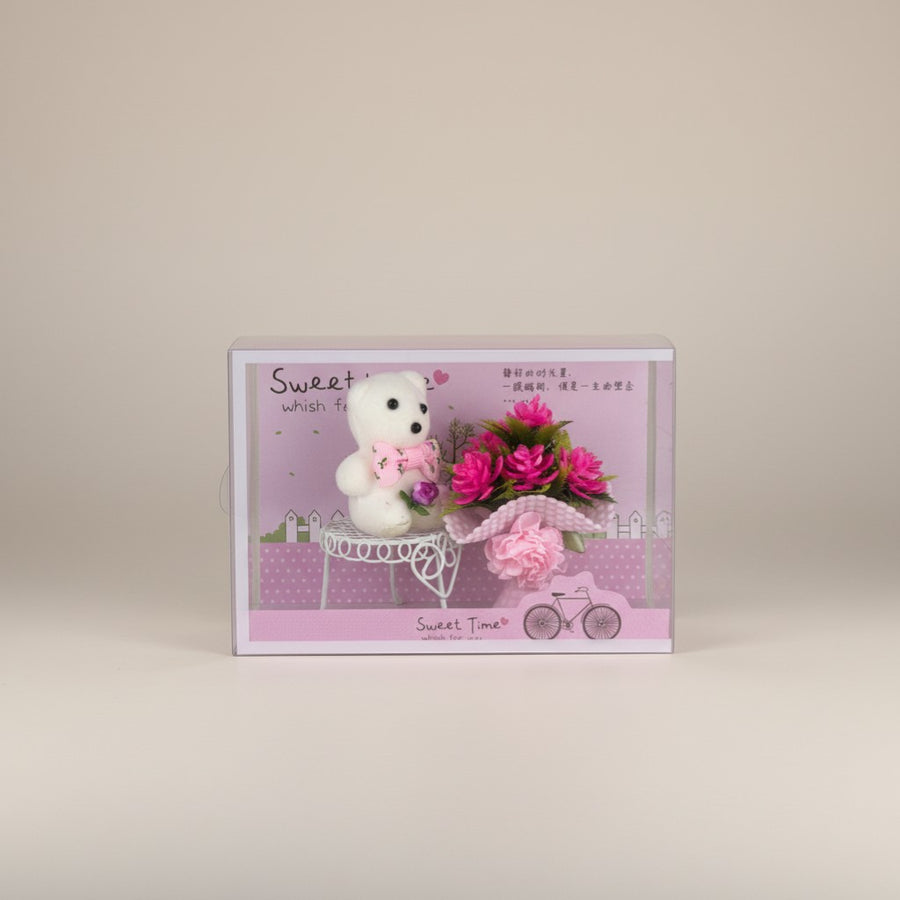 eRamis white teddy bear with pink bow and pink flower bouquet on a miniature white table
