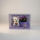 eRamisHere white teddy bear figurine with purple hat and flowers in a watering can, decorative set.